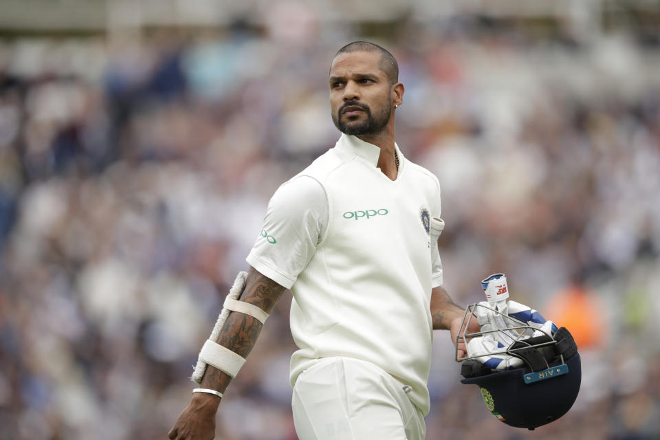 India's Shikhar Dhawan walks off the field of play after losing his wicket from the bowling of England's Stuart Broad during the fifth cricket test match of a five match series between England and India at the Oval cricket ground in London, Saturday, Sept. 8, 2018. (AP Photo/Matt Dunham)