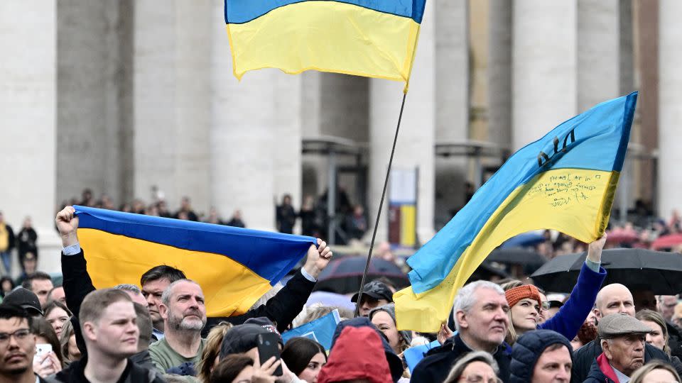 People wave Ukrainian flags at St.Peter's square as Pope Francis addresses the crowd on Sunday. - Alberto Pizzoli/AFP/Getty Images