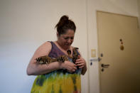 Lorena Alvarez holds some of her 28 pet "petauros," or sugar gliders, for which she has a permit, at her home in Buenos Aires, Argentina, Wednesday, Sept. 1, 2021. “I get up and I live for them. They are my engine of struggle and of life," she said of the animals that scamper over her looking to be petted, or leap and glide down to the floor. (AP Photo/Natacha Pisarenko)