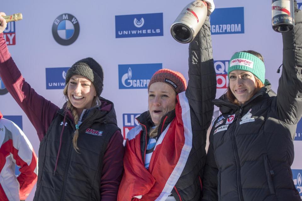 Second placed Kendall Wesenberg of the US, winner Mirela Rahneva of Canada and third placed Janine Flock of Austria, from left, celebrate after the women's skeleton World Cup in St. Moritz, Switzerland, on Friday, Jan. 20, 2017. (Urs Flueeler/Keystone via AP)
