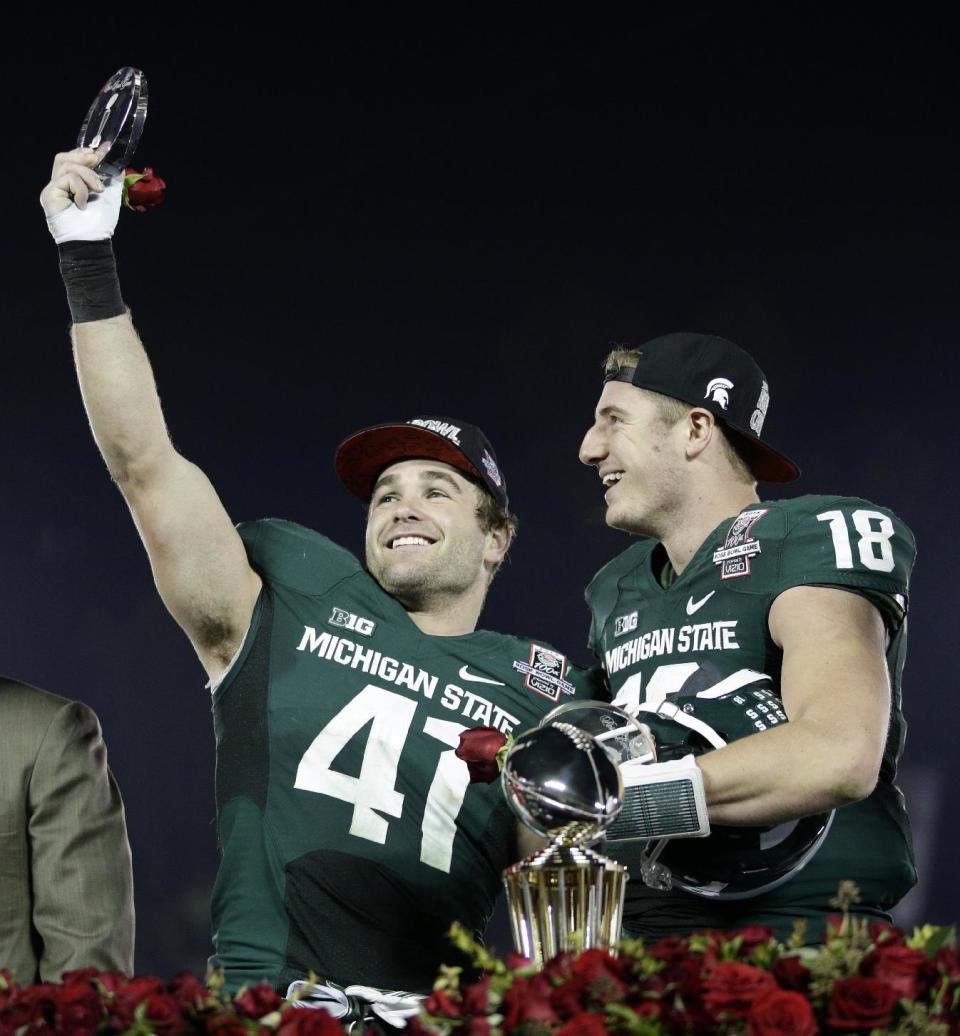 Michigan State linebacker Kyler Elsworth, left, celebrates with quarterback Connor Cook after Michigan State defeated Stanford 24-20 in the Rose Bowl NCAA college football game on Wednesday, Jan. 1, 2014, in Pasadena, Calif. (AP Photo/Jae C. Hong)