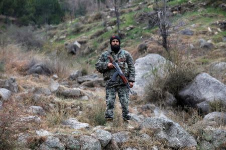 Pakistan's army soldier guards the area, after Indian military aircrafts struck on February 26, according to Pakistani officials, in Jaba village, near Balakot, Pakistan, March 7, 2019. REUTERS/Akhtar Soomro