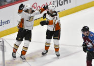 Anaheim Ducks left wing Rickard Rakell (67) celebrates his overtime goal with defenseman Christian Djoos (29), as Colorado Avalanche defenseman Samuel Girard (49) skates by during an NHL hockey game Wednesday, March 4, 2020, in Denver. The Ducks won 3-2 in overtime. (AP Photo/John Leyba)