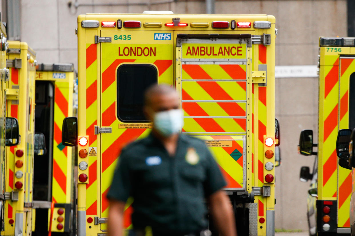 A paramedic walks past ambulances outside the emergency department of the Royal London Hospital in London, England, on January 26, 2021. Data from the UK's official statistics bodies revealed today that, based on death certificates, up to January 15 this year nearly 104,000 people have died with coronavirus since the pandemic began. Government figures, which are based on deaths within 28 days of a positive covid-19 test, remain slightly lower, yesterday standing at 98,531. (Photo by David Cliff/NurPhoto via Getty Images)