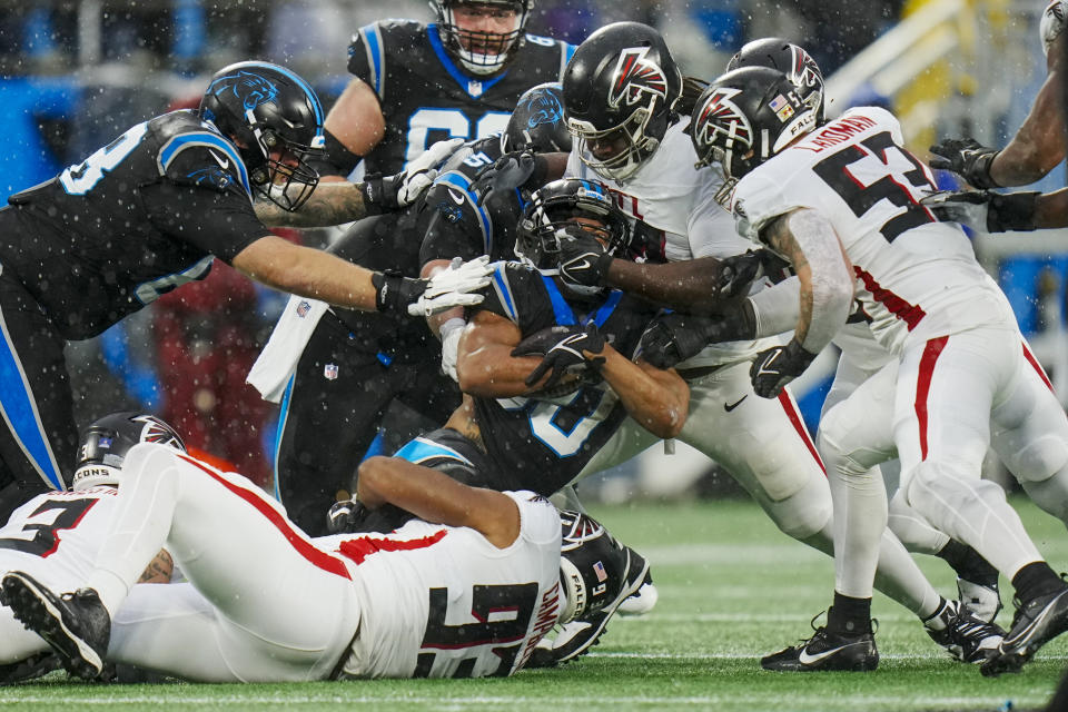 Carolina Panthers running back Chuba Hubbard is tackled by the Atlanta Falcons during the first half of an NFL football game Sunday, Dec. 17, 2023, in Charlotte, N.C. (AP Photo/Rusty Jones)