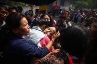 Daughter of Nepalese mountaineer Ang Kaji Sherpa, killed in an avalanche on Mount Everest, cries during the funeral ceremony in Katmandu, Nepal, Monday, April 21, 2014. Buddhist monks cremated the remains of Sherpa guides who were buried in the deadliest avalanche ever recorded on Mount Everest, a disaster that has prompted calls for a climbing boycott by Nepal's ethnic Sherpa community. The avalanche killed at least 13 Sherpas. Three other Sherpas remain missing. (AP Photo/Niranjan Shrestha)