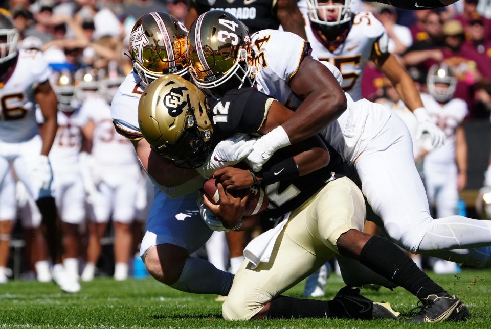 Minnesota's Boye Mafe helps sack Colorado quarterback Brendon Lewis.