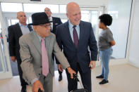 CORRECTS CITY TO KENNER, NOT BATON ROUGE- Former New Orleans Mayor Mitch Landrieu, right, greets Dr. Norman C. Francis, former President of Xavier University of Louisiana, as he arrives at a ribbon cutting ceremony for the opening the newly built main terminal of the Louis Armstrong New Orleans International Airport in Kenner, La., Tuesday, Nov. 5, 2019. (AP Photo/Gerald Herbert)