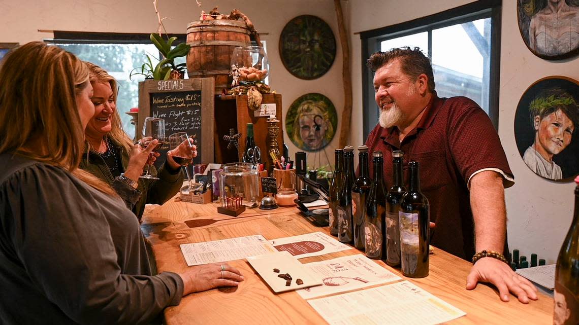 Eric Hays, owner of Chateau Davell, pours wines for visitors in the tasting room of his winery in Camino last month. Lezlie Sterling/lsterling@sacbee.com