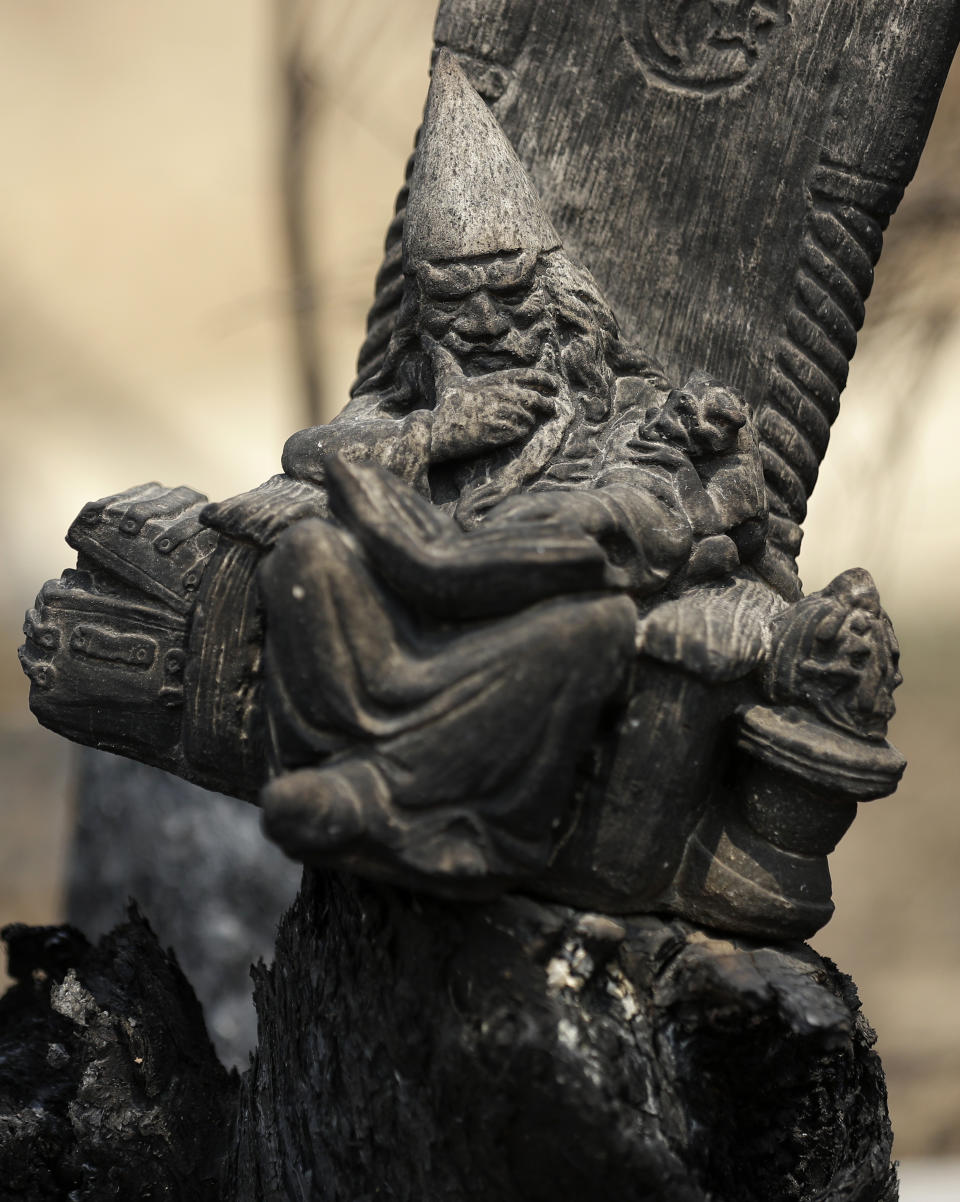 A blackened wizard ornament sits in a scorched fencepost at Nerrigundah, Australia, Monday, Jan. 13, 2020, after a wildfire ripped through the town on New Year's Eve. The tiny village of Nerrigundah in New South Wales has been among the hardest hit by Australia's devastating wildfires, with about two thirds of the homes destroyed and a 71-year-old man killed. (AP Photo/Rick Rycroft)