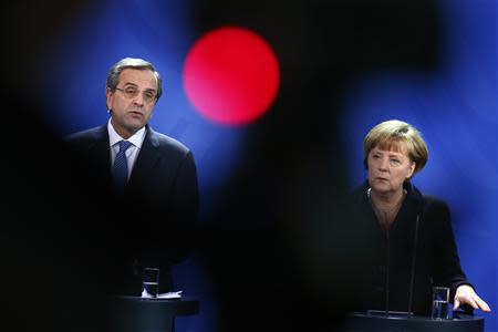 German Chancellor Angela Merkel and Greece's Prime Minister Antonis Samaras attend a news conference after talks at the Chancellery in Berlin, November 22, 2013. REUTERS/Thomas Peter