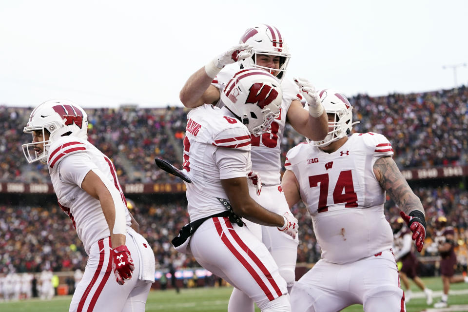 Wisconsin wide receiver Will Pauling, center front, celebrates with teammates after catching an 11-yard touchdown pass during the first half of an NCAA college football game against Minnesota, Saturday, Nov. 25, 2023, in Minneapolis. (AP Photo/Abbie Parr)