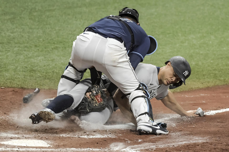 Tampa Bay Rays catcher Mike Zunino, left, tags out New York Yankees' Giancarlo Stanton at the plate as he tried to score from third base on an infield ground ball hit by New York's Gio Urshela during the eighth inning of a baseball game Tuesday, May 11, 2021, in St. Petersburg, Fla. (AP Photo/Steve Nesius)