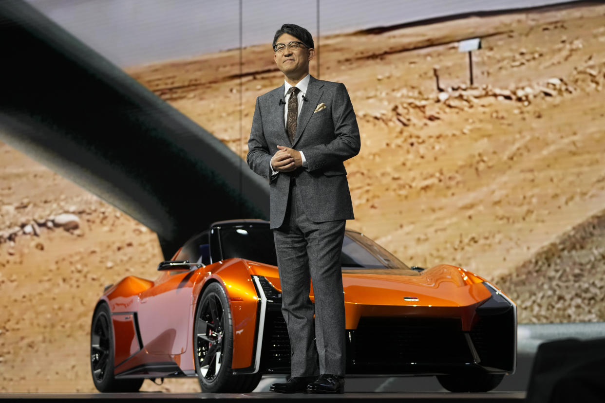 Toyota Motor Corp. CEO Koji Sato, standing in front of the sporty FT-Se, speaks during a briefing on the media day at the Japan Mobility Show in Tokyo, Wednesday, Oct. 25, 2023. (AP Photo/Hiro Komae)