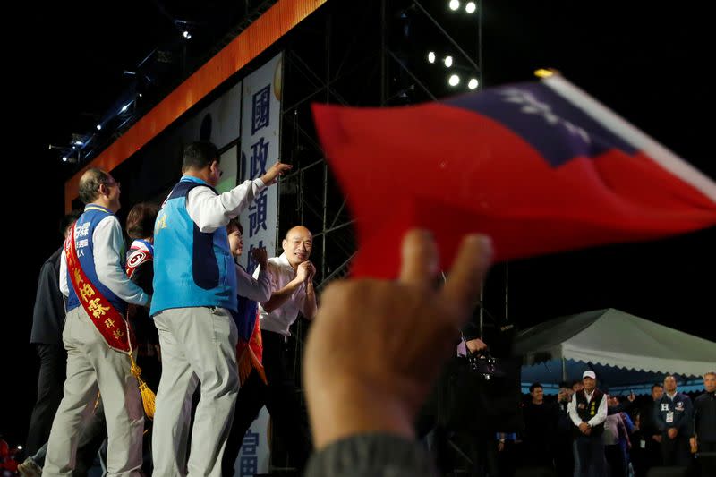 Kuomintang party's presidential candidate Han Kuo-yu reacts to his supporters during an election rally in Kaohsiung