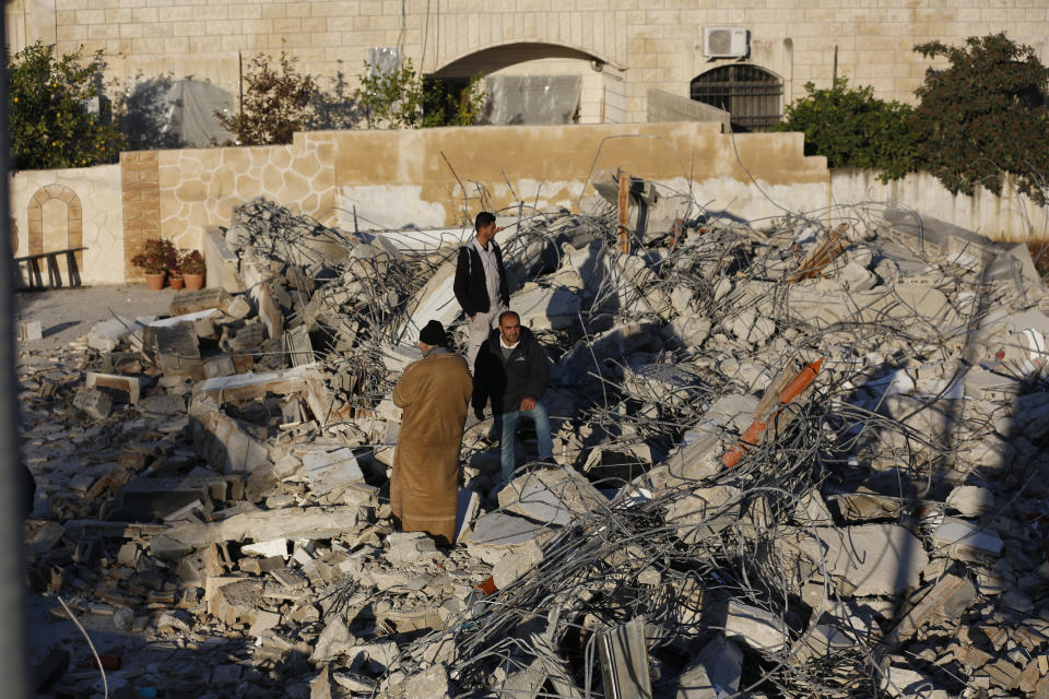 Palestinians inspect a house after it was demolished by the Israeli army in the West Bank city of Jenin, Thursday, Feb. 6, 2020. Israeli military spokesman Lt. Col. Jonathan Conricus said troops were carrying out the demolition of a home belonging to a militant allegedly involved in a deadly attack. (AP Photo/Majdi Mohammed)