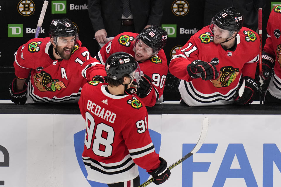 Chicago Blackhawks center Connor Bedard (98) is congratulated by teammates after his goal during the first period of an NHL hockey game against the Boston Bruins, Wednesday, Oct. 11, 2023, in Boston. (AP Photo/Charles Krupa)