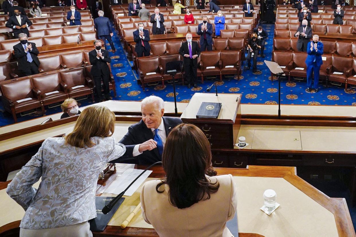 President Joe Biden elbow bumps with House Speaker Nancy Pelosi of Calif., left, as he arrives to address a joint session of Congress, Wednesday, April 28, 2021, in the House Chamber at the U.S. Capitol in Washington. Vice President Kamala Harris stands and applauds.