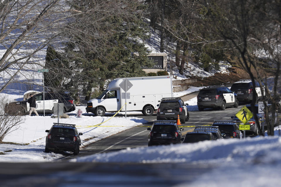 Law enforcement vehicles are parked near the scene where two police officers and a first responder were shot and killed Sunday, Feb. 18, 2024, in Burnsville, Minn. (AP Photo/Abbie Parr)