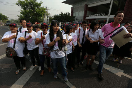 FILE PHOTO: Pro-democracy activists, who staged a demonstration last month to protest a delay to a general election, gesture as they arrive at the police station in Bangkok, Thailand, February 8, 2018. Picture taken February 8, 2018. REUTERS/Athit Perawongmetha/File Photo