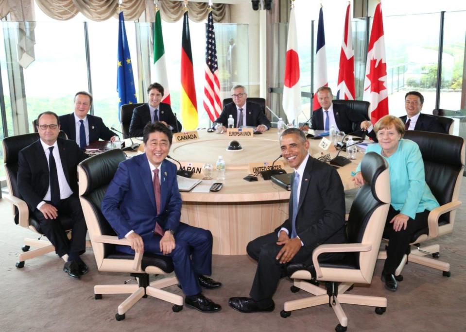 Japanese Prime Minsiter Shinzo Abe, foreground center left, and U.S. President Barack Obama, foreground center right, smile at photographers with other leaders of Group of Seven industrial nations, clockwise from left, French President Francois Hollande, British Prime Minister David Cameron, Canadian Prime Minister Justin Trudeau, European Commission President Jean-Claude Juncker, European Council President Donald Tusk, Italian Prime Minister Matteo Renzi and German Chancellor Angela Merkel, at the start of the second working session of the G-7 summit meetings in Shima, Mie Prefecture, Japan, Thursday, May 26, 2016. (Japan Pool via AP) 