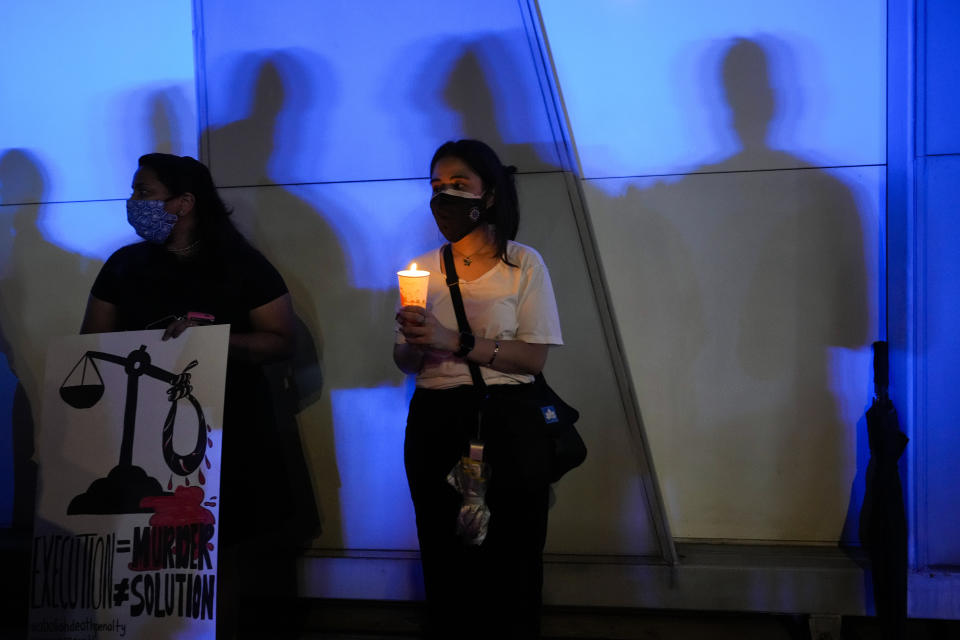 Activists stage a protest against the impending execution of Nagaenthran K. Dharmalingam, sentenced to death for trafficking heroin into Singapore, during a candlelight vigil gathering outside the Singaporean Embassy in Kuala Lumpur, Malaysia, Tuesday, April 26, 2022. The Singapore Court of Appeal has dismissed a last-minute legal challenge filed by the mother of a mentally disabled Malaysian man in an attempt to halt his execution for drug trafficking. (AP Photo/Vincent Thian)