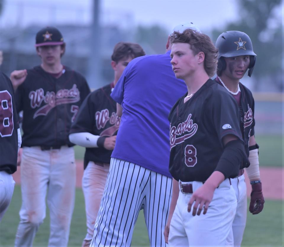 Windsor High School baseball players walk through the postgame handshake line Saturday, May 20, 2023, after losing a Class 4A regional championship game to Lutheran in Windsor, Colo.