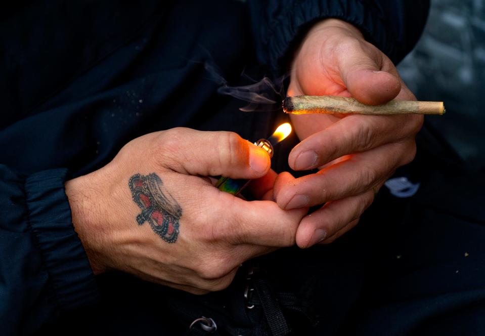 In this file photo, a joint gets lit at the Finger Lakes Music, Comedy and Cannabis Festival in Spencer, Saturday, Sept. 25, 2021.