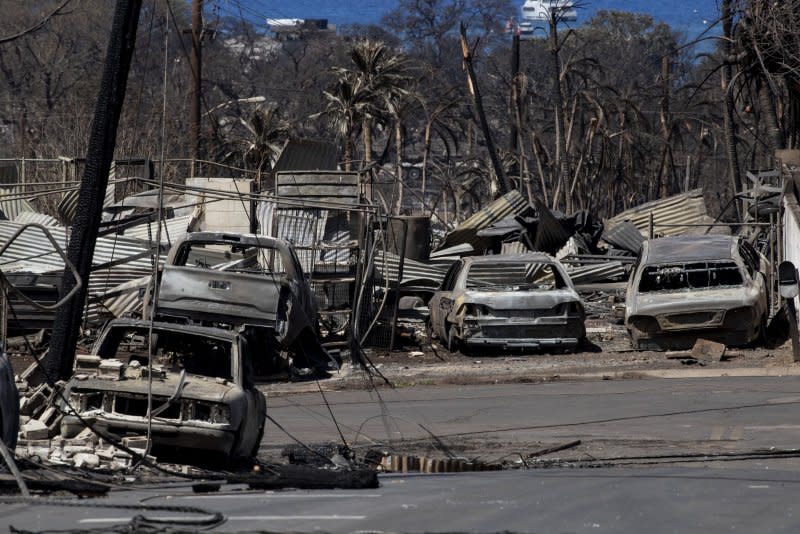 Burnt cars and houses are the only remains after a wild fire swept through a neighborhood in Lahaina, Hawaii, on August 11. Etienne Laurent/EPA-EFE