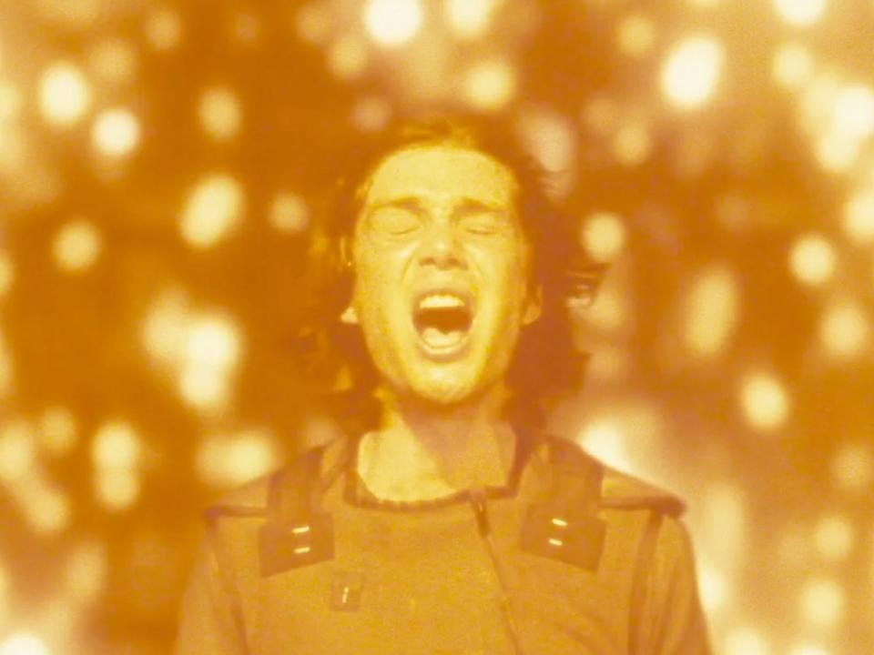 Cillian Murphy in a scene from "Sunshine" where Robert Capa is screaming while surrounded by motes of light.