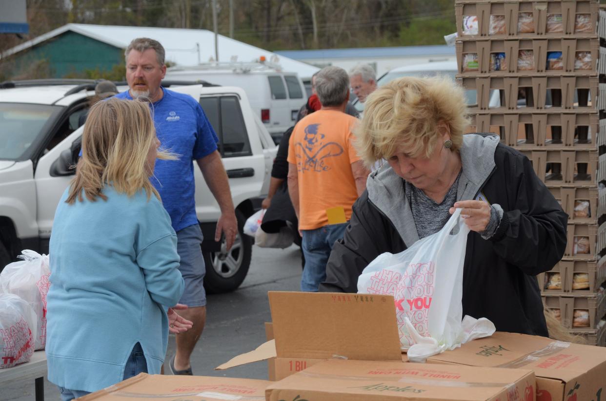 Staff and volunteers with Religious Community Services fill food boxes to hand out in Bridgeton on March 23 as part of the nonprofit's Operation Outpost initiative.