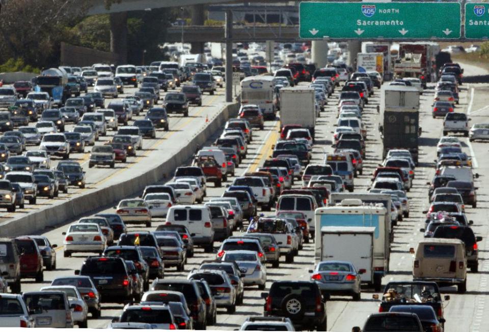 FILE - In this May 28, 2010 file photo, the rush hour commute starts in early afternoon and with greater intensity as traffic is jammed in both directions on Interstate 405 on the Westside of Los Angeles as commuters and vacationers hit the road. With a little advance planning, and some insider tips, summer vacations can be a lot less expensive. ( (AP Photo/Reed Saxon, file)