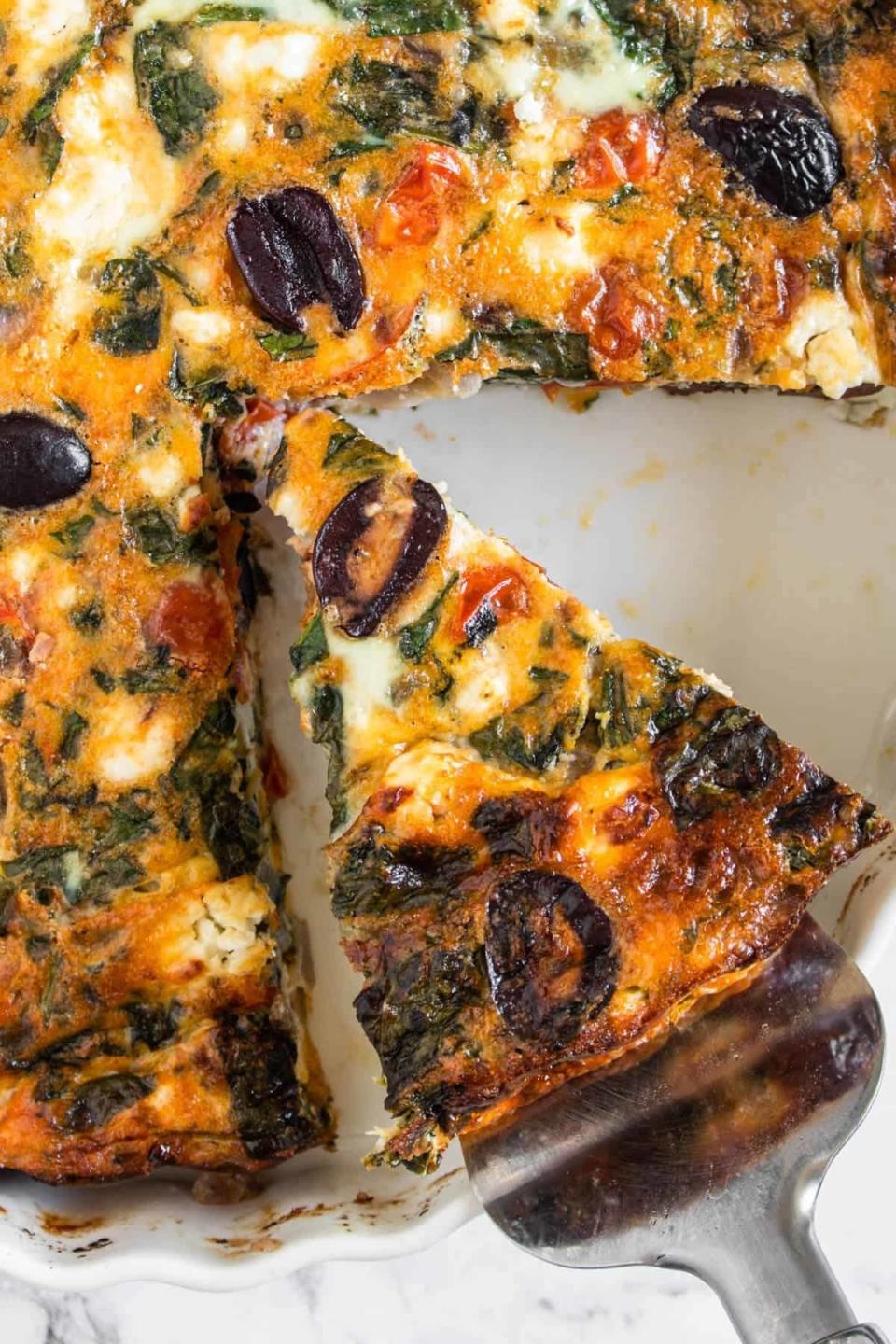 Taking a slice of Mediterranean frittata.