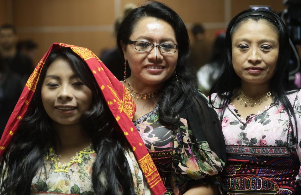 Guna indigenous women pose for a photo wearing traditional dresses decorated with Molas, after a press conference where Guna leaders demanded that the sports shoe company Nike remove their traditional Mola handcraft print from a shoe design, in Panama City, Tuesday, May 21, 2019. Nike said in a statement that it has canceled the launch of the "Nike Air Force 1 ‘Puerto Rico" trainer, with which it intended to pay homage to Puerto Rico. (AP Photo/Arnulfo Franco)