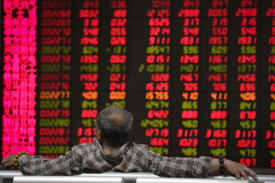 A man looks at an electronic board displaying stock prices at a brokerage house in Beijing, Wednesday, April 24, 2019. Shares were mostly lower in Asia on Wednesday despite the S&P 500’s all-time record high close the day before. (AP Photo/Andy Wong)