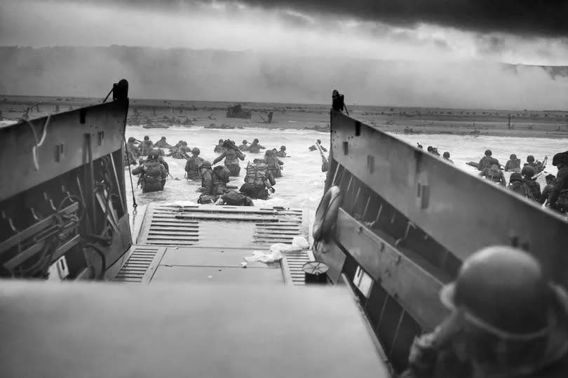 Getty images: Digitally restored vintage World War II photo of American troops wading ashore on Omaha Beach during the D-Day invasion on June 6, 1944