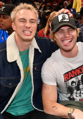 <p>Paras Griffin/Getty </p> Drew Starkey and Chase Stokes at a basketball game