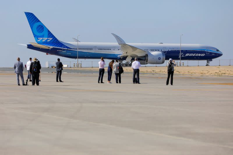 FILE PHOTO: FILE PHOTO: Visitors stand in front of the plane Boeing 777X during the Dubai Airshow, in Dubai
