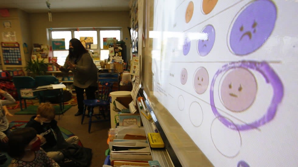 Second-grade teacher Melissa Shugg teaches a lesson at Paw Paw Elementary School about thoughts, feelings and action, with the lesson displayed via projector