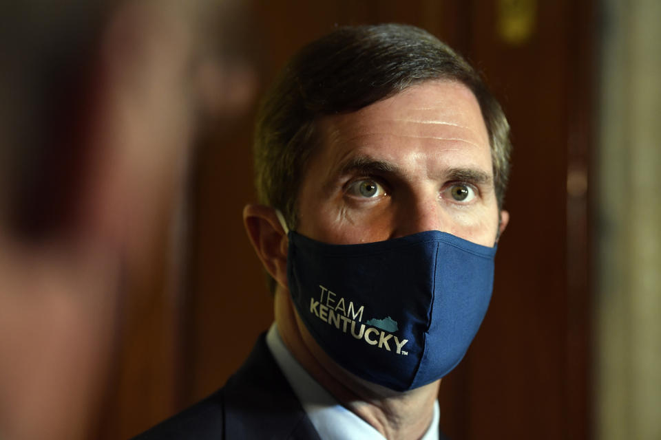 Kentucky Governor Andy Beshear listens to a reporters question following the signing of bills related to the American Rescue Plan Act at the Kentucky State Capitol in Frankfort, Ky., Wednesday, April 7, 2021. (AP Photo/Timothy D. Easley)