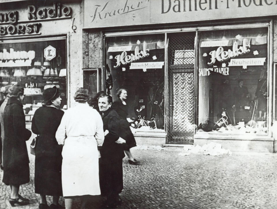 FILE - The November 1938 file photo shows a group of people standing outside a Jewish-owned shop in an unnamed German town, after the Kristallnacht, when Nazi-incited mass riots left more than 91 jews dead, damaged more than 1,000 synagogues and left some 7,500 Jewish businesses ransacked and looted. The Conference on Jewish Material Claims Against Germany, also referred to as the Claims Conference, presents an interactive, virtual reality experience project to tell the story about the pogroms of the Kristallnacht or 'Night of broken glass'. (AP Photo, File)