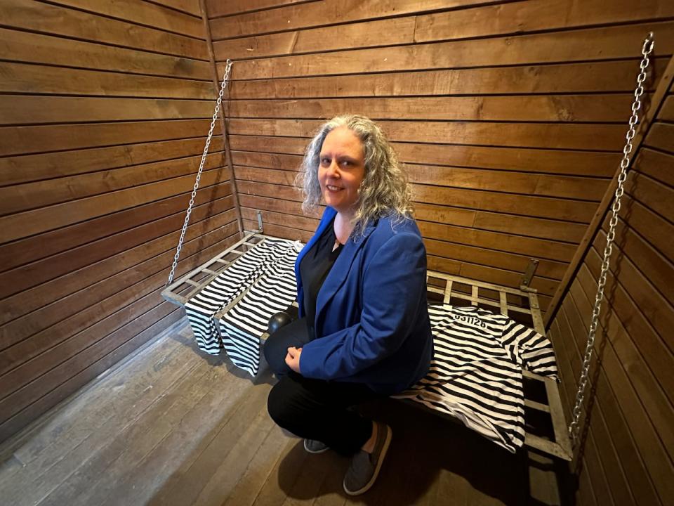 West Elgin deputy mayor Taraesa Tellier sits inside one of the jail's small cells. 