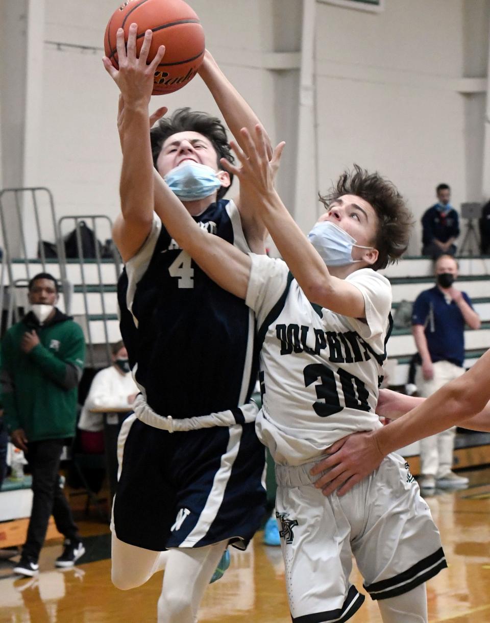 In this January 2022 game, Carlos Aguilar of Nantucket and Connor Bosiak of D-Y reach for a rebound.