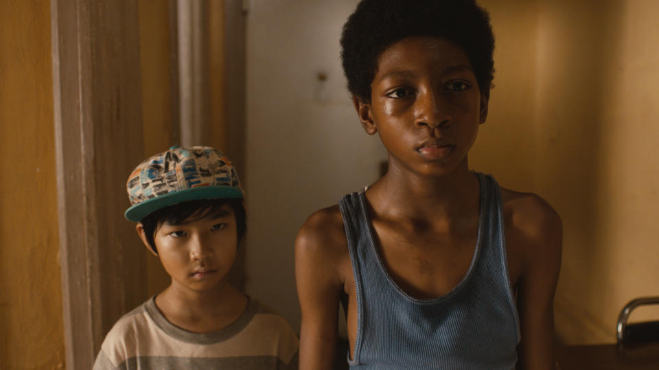 This photo released by Lions Gate Entertainment, Inc. shows Skylan Brooks, right, as Mister and Ethan Dizon as Pete in a scene from the film, "The Inevitable Defeat of Mister & Pete." Starring alongside Jennifer Hudson, Anthony Mackie, Jeffrey Wright and Jordin Sparks, the young actors offer moving portrayals of Mister and Pete, two boys forsaken by their drug addict mothers and left to fend for themselves through a sweltering summer. The film releases Friday, Oct. 11, 2013. (AP Photo/Copyright Lions Gate Entertainment, Inc.)