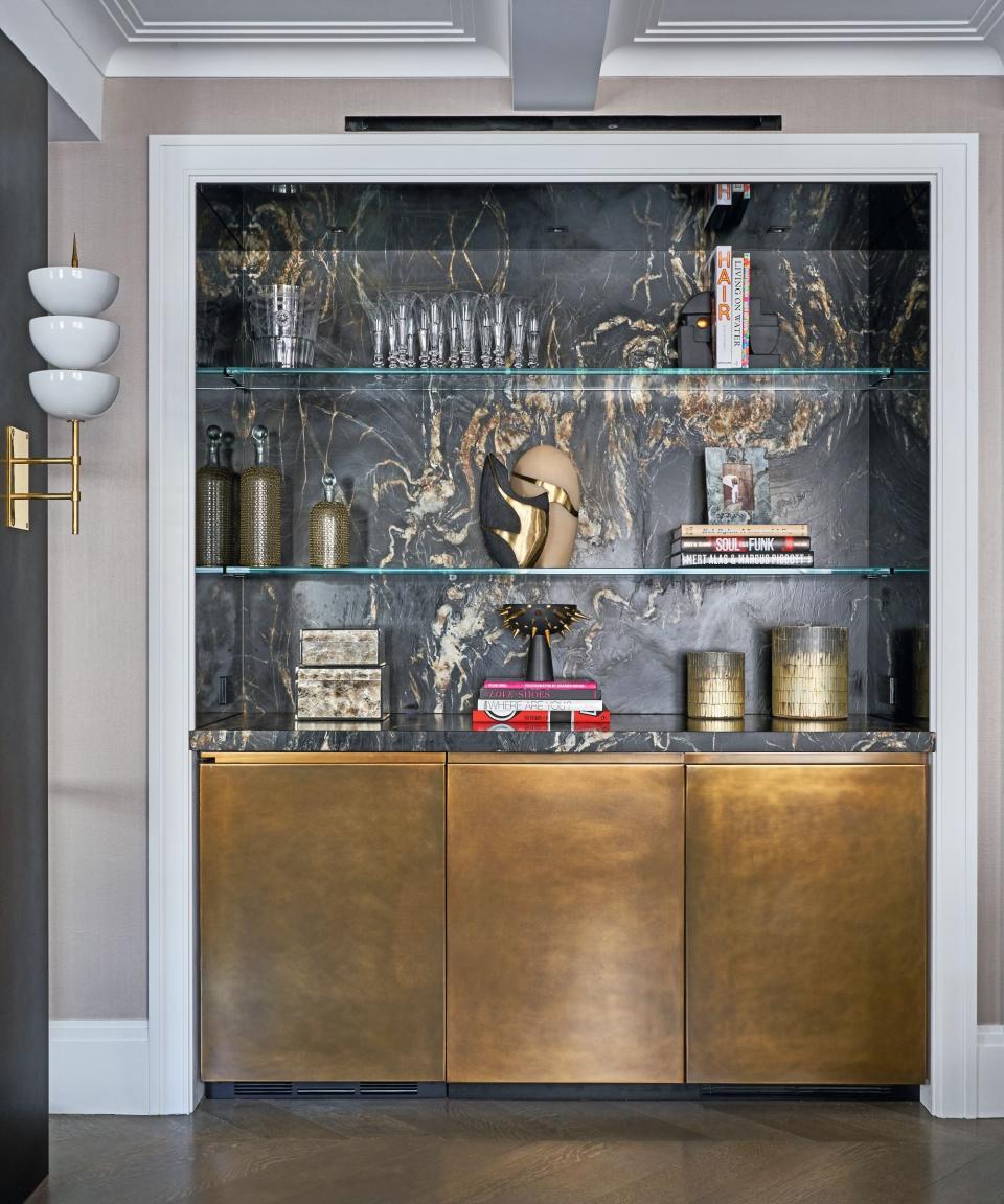 Home bar with countertop and backsplash in dark marble