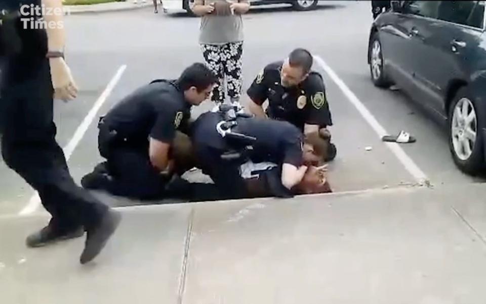 Members of a May 13 crowd gathered in the Erskine-Walton neighborhood sounded alarmed and shouted for the three or more Asheville Police Department officers to stop as they struggled with Devon Lewis Rayshawn Whitmire on the ground.