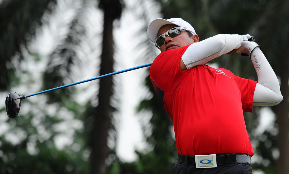 Thailand's Prayad Marksaeng watches his shot on the sixth hole during the third round of the EurAsia Cup golf tournament at the Glenmarie Golf and Country Club in Subang, Malaysia, Saturday, March 29, 2014. (AP Photo/Joshua Paul)