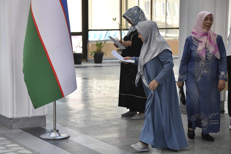 Women walk to cast their ballots at a polling station during a referendum in Tashkent, Uzbekistan, Sunday, April 30, 2023. Voters in Uzbekistan are casting ballots in a referendum on a revised constitution that promises human rights reforms. But the reforms being voted on Sunday also would allow the country's president to stay in office until 2040. (AP Photo)