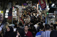 People walk through the old main bazaar of Tehran, Iran, Thursday, June 13, 2024. The rise of the “Hamster Kombat” app in Iran highlights a harsher truth facing the Islamic Republic's economy ahead of its presidential election this week to replace the late President Ebrahim Raisi, who died in a helicopter crash in May. (AP Photo/Vahid Salemi)