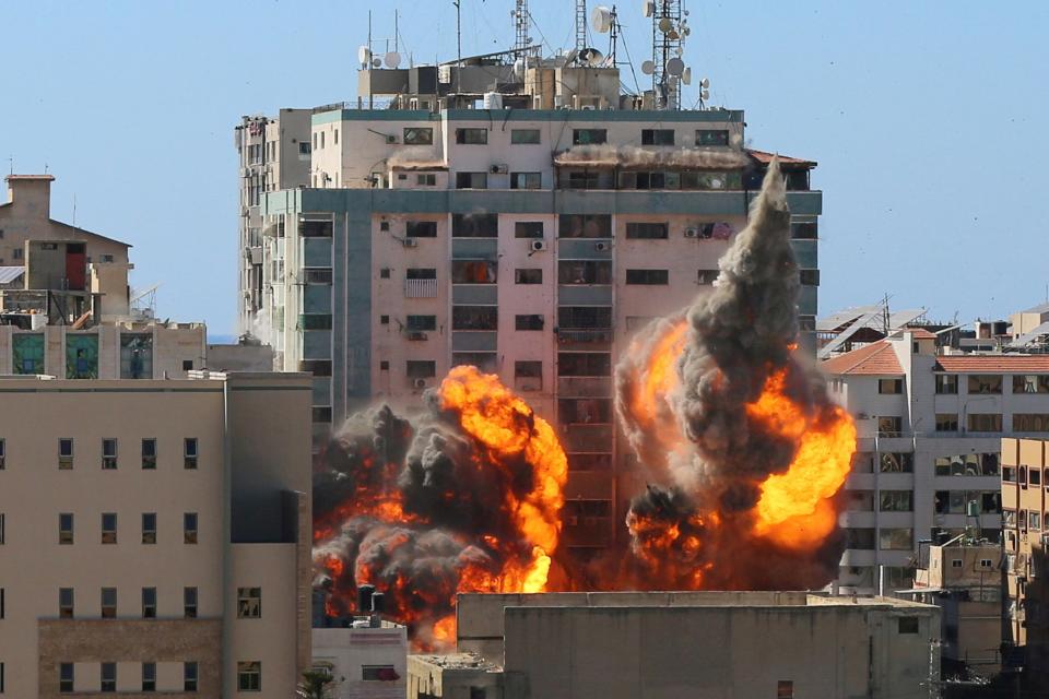 Image: A tower housing AP, Al-Jazeera offices collapses after Israeli missile strikes (Stringer / Reuters)